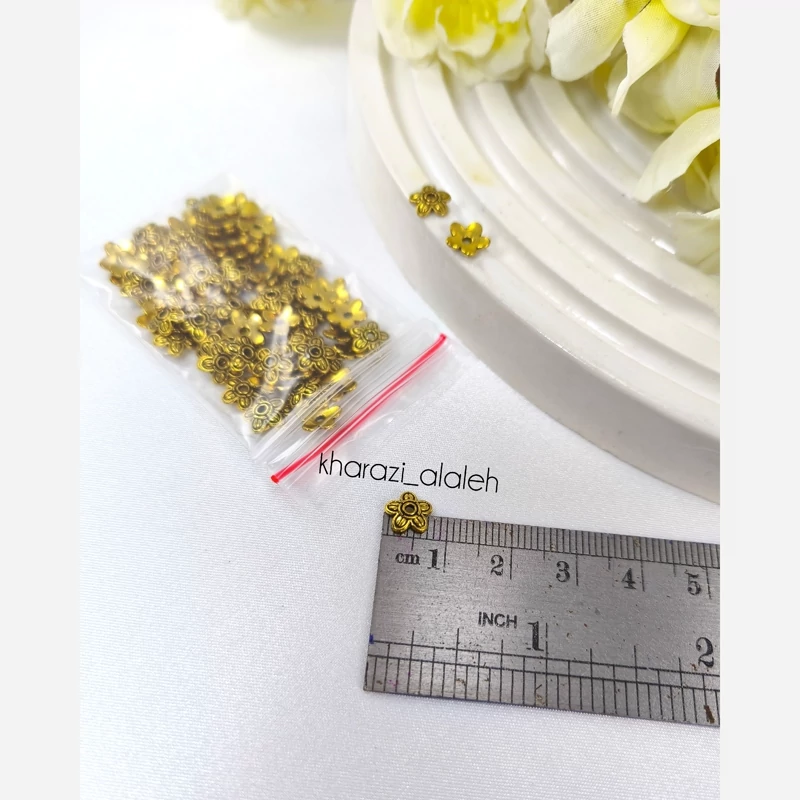 خرجکار کاسبرگ طلایی طرح شکوفه گیلاس (فروش به صورت بسته 15 گرمی و تقریباً 80 عددی)