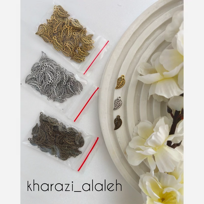 خرجکار آویز برنزی و طلایی طرح برگ (فروش به صورت بسته 15 گرمی و تقریباً 50 عددی)