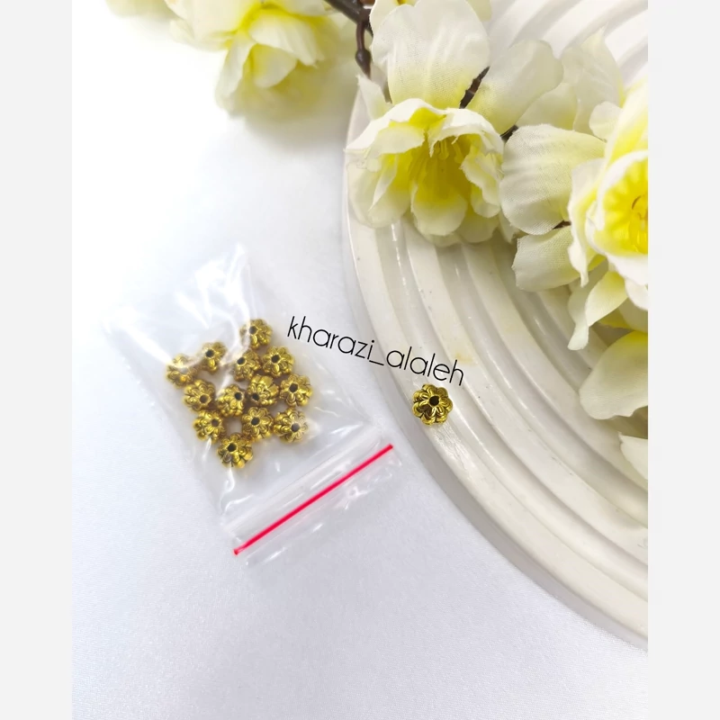 خرجکار بین مهره طلایی طرح گوی بزرگ (فروش به صورت بسته 15 گرمی و تقریباً 14 عددی)
